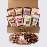 Box of Choc'd Full chocolate snacks with packaging and a plate of assorted snacks.